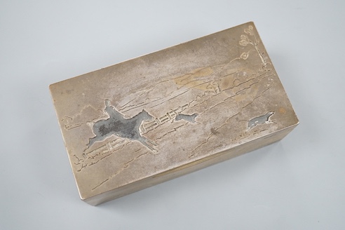 A George V silver mounted rectangular cigarette box, by Goldsmiths &Silversmiths Co. Ltd, London, 1910, the cover with 'cut out' hunting scene, 16.5cm.